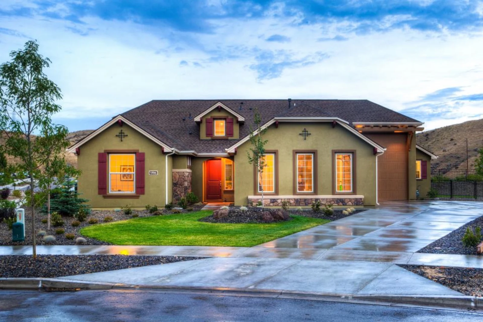 Bramblewood landscaping project with green lawn, curved curbing and decorative river rock in Northern Utah
